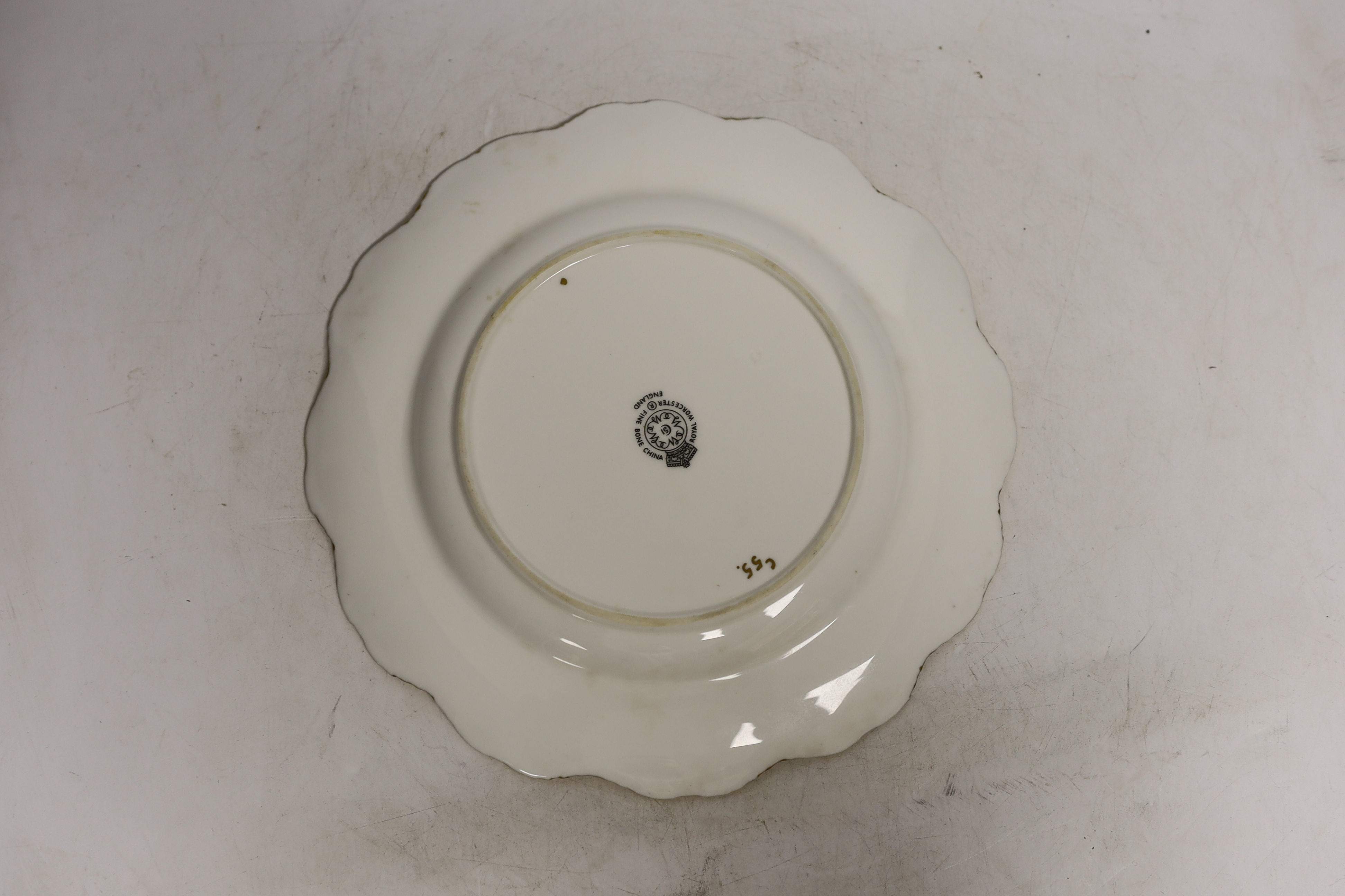 A pair of Royal Worcester fruit painted plates, post war, signed Freeman, 22.5cm